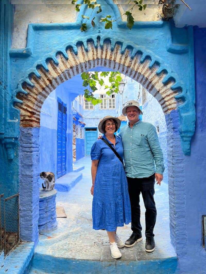 couple standing in blue laneway in Chefchaouen, Morocco