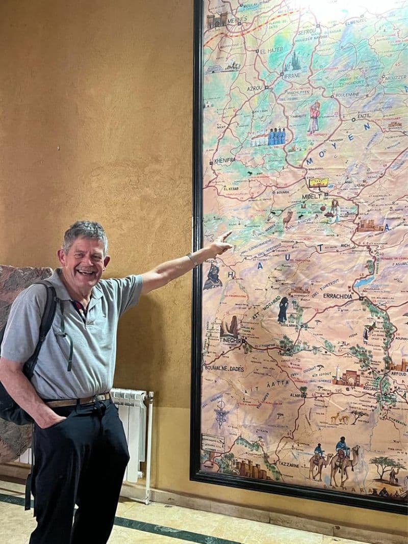 man pointing to large map of Morocco