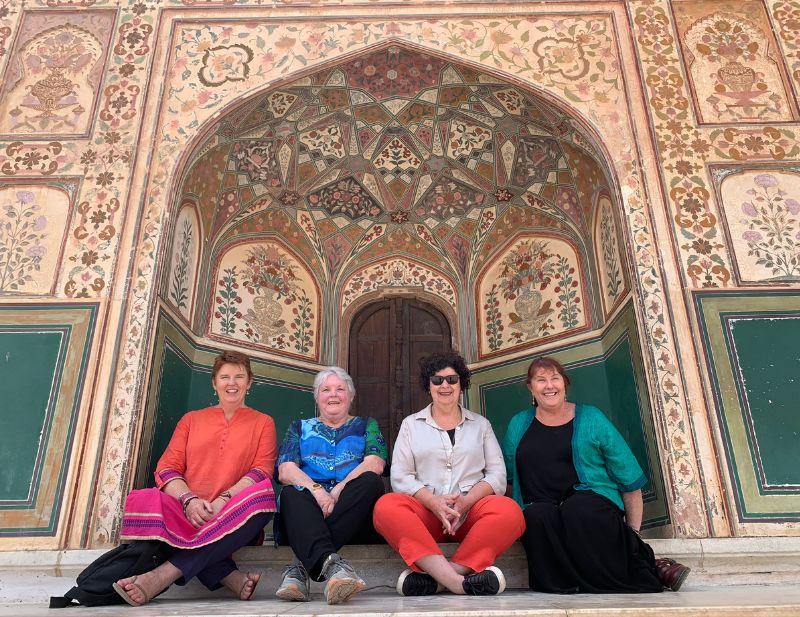 4 ladies sitting in front of gate at Amber Fort